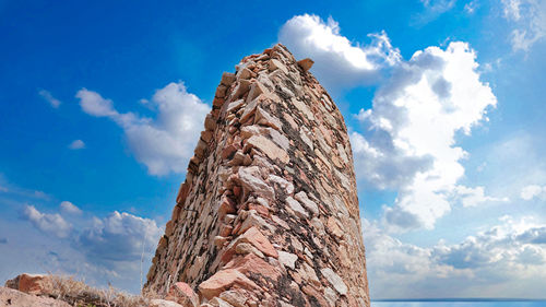 Low angle view of rock formations against sky