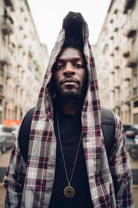 Confident young man in hooded jacket