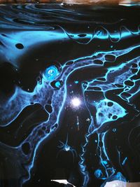 Stellar black and blue fading galactic acryalic pour painting 