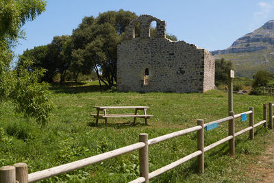 Built structure on field against sky