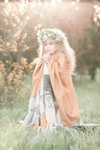 Portrait of girl wearing wreath at park