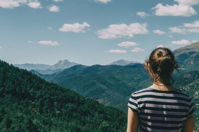 Girl walking along a small path in the mountain of spain. on a sunny summer day