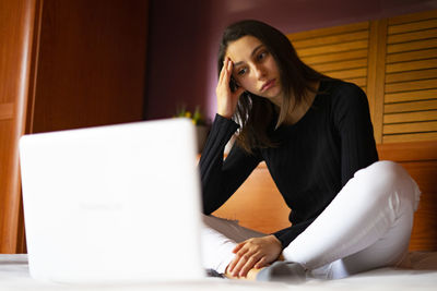 Frustrated and sad unemployed woman with the computer.