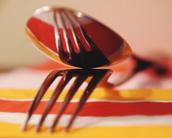 Close-up of spoon and fork on table