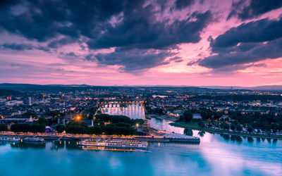 High angle view of illuminated buildings against sky at sunset