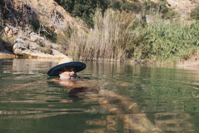 Mature caucasian man bathing in the river person