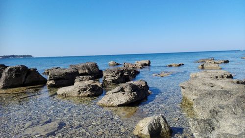 Scenic view of sea against clear blue sky