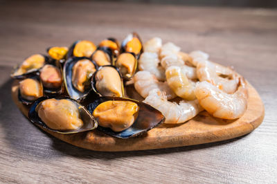 Close-up of cooked mussels. boiled black mussels in shell shell with shrimps, appetizer or snack