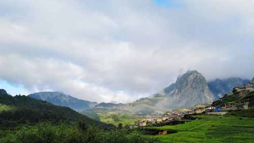 Scenic view of mountains against cloudy sky