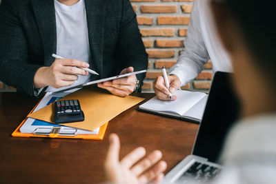 Midsection of businessman working at office