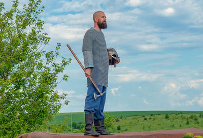 Ax in the hands of medieval viking warrior. metal helmet and chain mail. filming historical film.