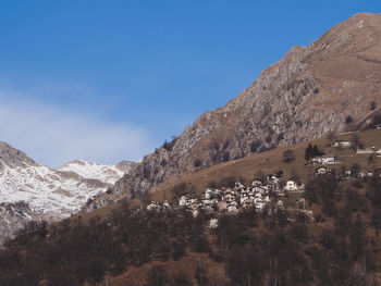 Scenic view of mountains against blue sky