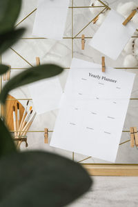 High angle view of paper hanging on table at home