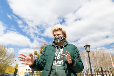 Portrait of man standing against sky