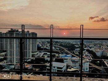 Cityscape against sky at sunset