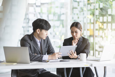 People working on table in office