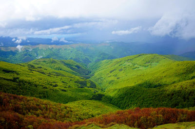 Scenic view of mountains against cloudy sky