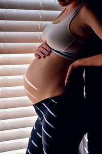 Midsection of woman wearing hat