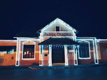 Facade of building against sky at night