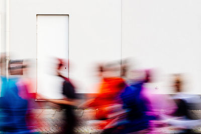 Blurred motion of people walking on road