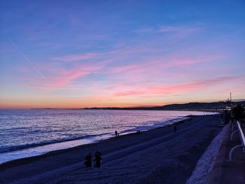 Scenic view of beach against sky during sunset