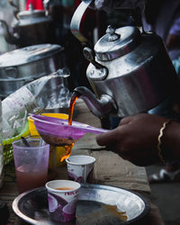 Midsection of man preparing food in container
