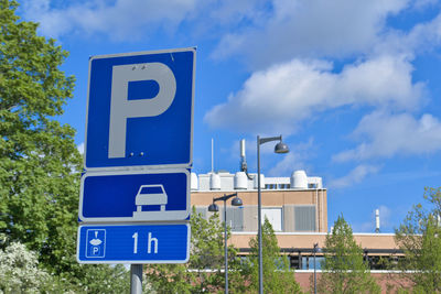 Low angle view of road sign against sky