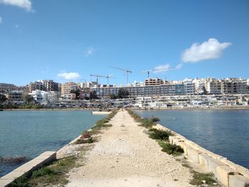 Scenic view of sea and buildings against sky