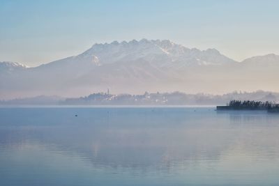 Scenic view of lake and mountains against sky