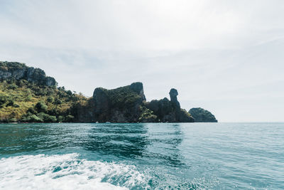 Scenic view of rocks in sea against sky