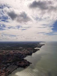 High angle view of buildings by sea against sky