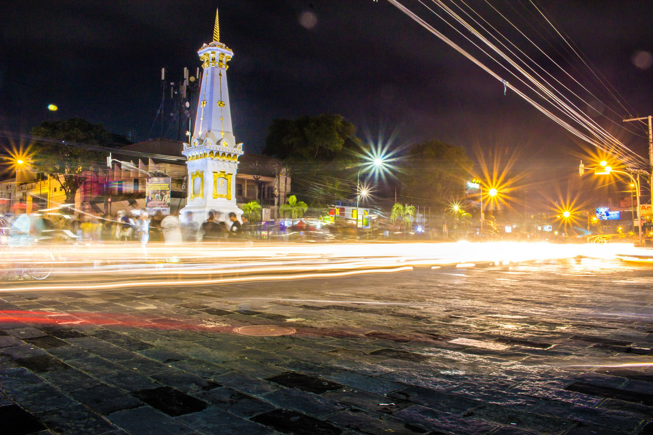 LIGHT TRAILS ON STREET AT NIGHT