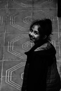 Portrait of a smiling girl standing outdoors