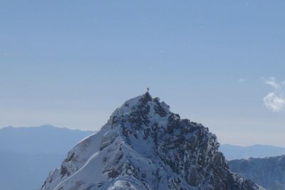 Low angle view of snowcapped mountains against sky