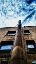 Low angle view of building against cloudy sky