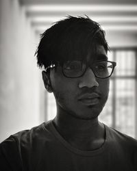 Close-up portrait of young man wearing eyeglasses