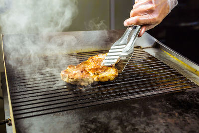 Man preparing food on barbecue grill