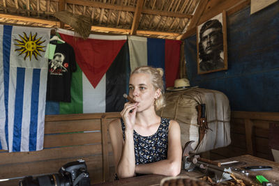 Portrait of woman sitting on table