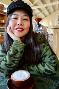 Portrait of young woman with coffee