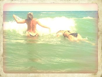 Woman jumping in sea
