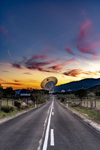 People on road against sky during sunset