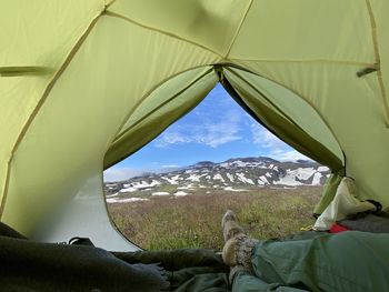 Low section of person relaxing in tent