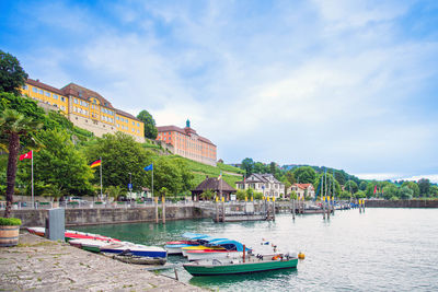 Boats in river against sky