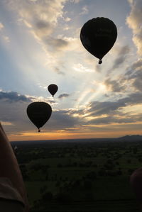 Hot air balloons flying over landscape