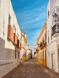 Street amidst buildings against sky