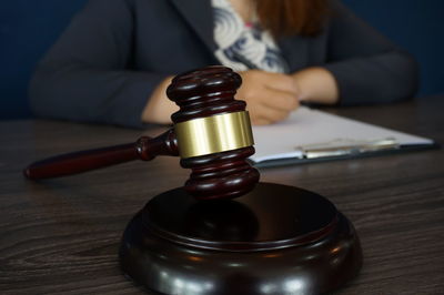 Close-up of person holding tea cup on table