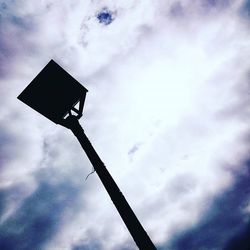 Low angle view of street light against cloudy sky