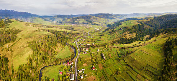 Aerial view of green landscape against sky