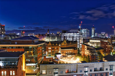 High angle view of buildings in city at night