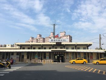 View of city street and buildings against sky